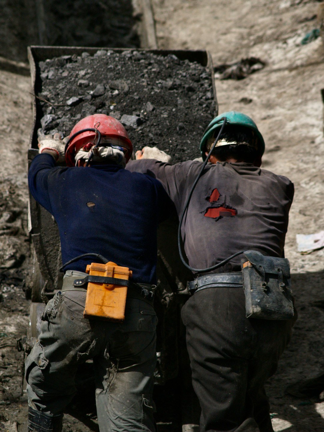 2 men in blue jacket wearing helmet
