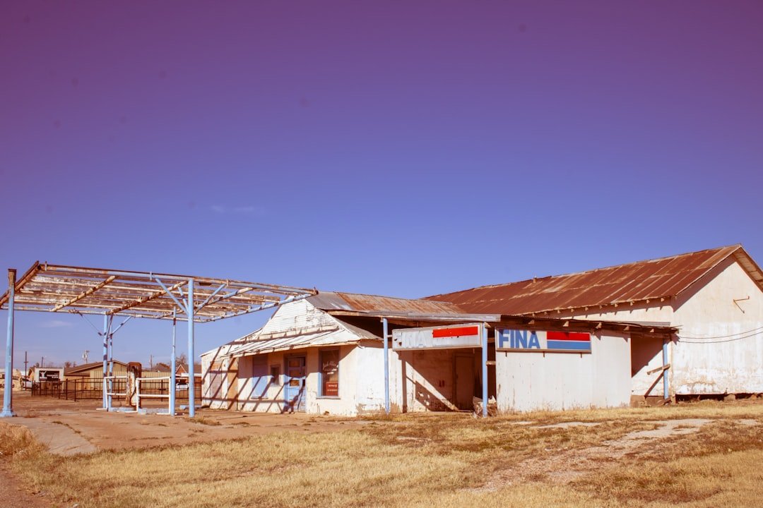 an old run down building with a metal roof