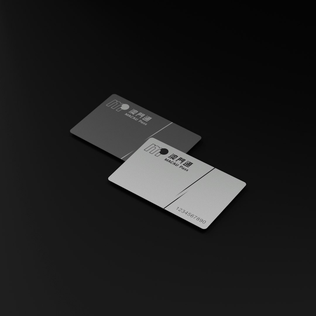 Two minimalist credit cards on a dark surface.