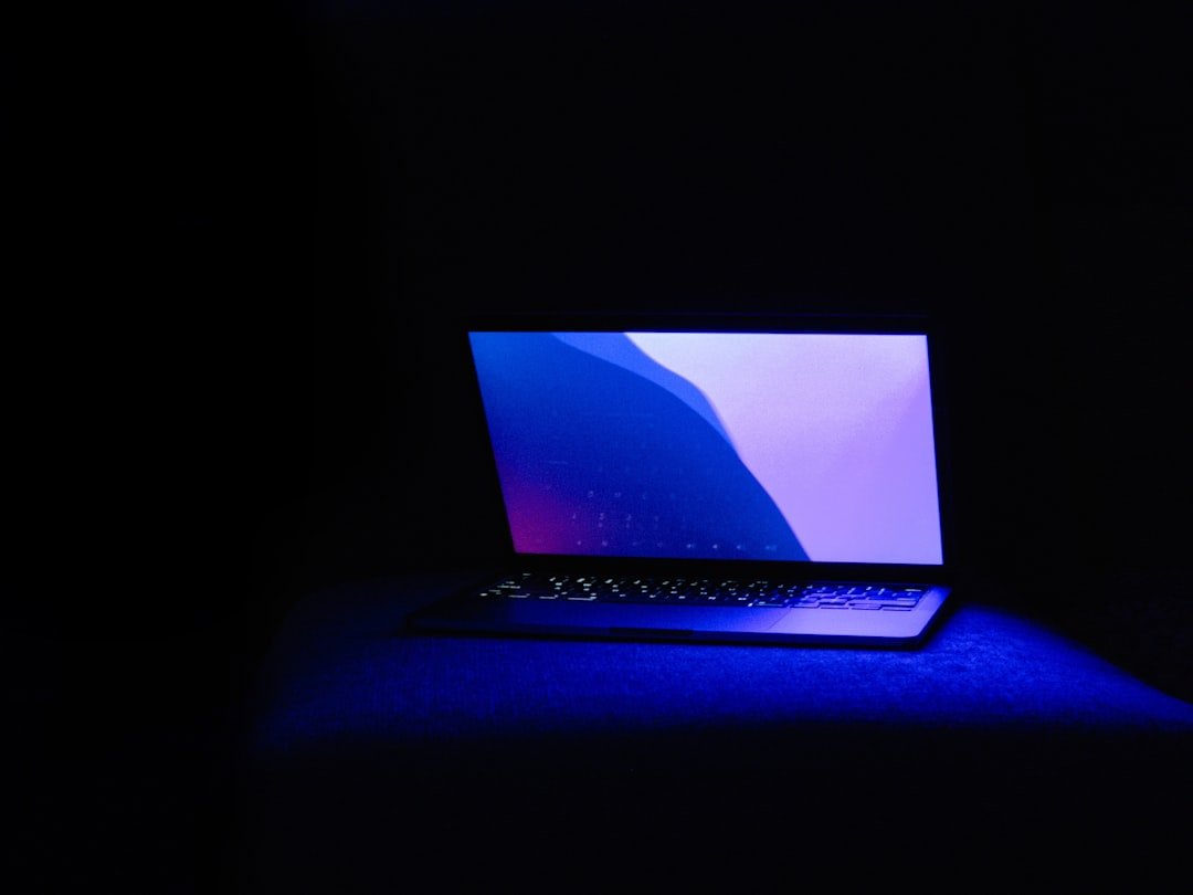 Laptop with glowing keyboard and blue light