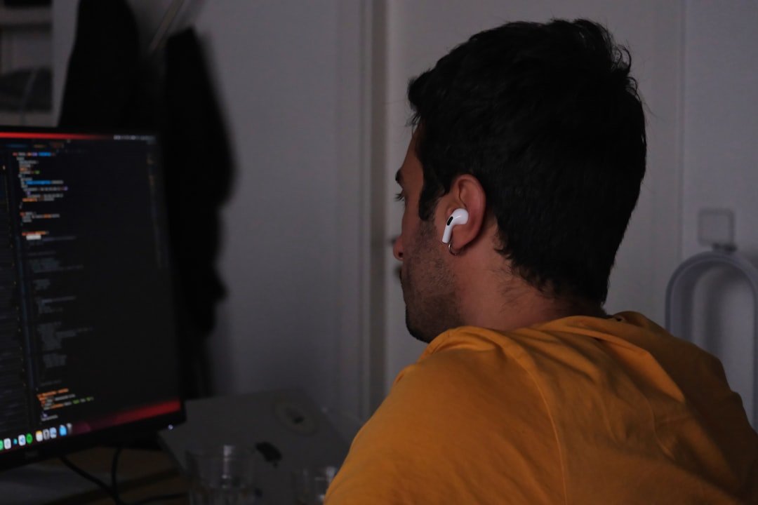 A man sitting in front of a computer monitor