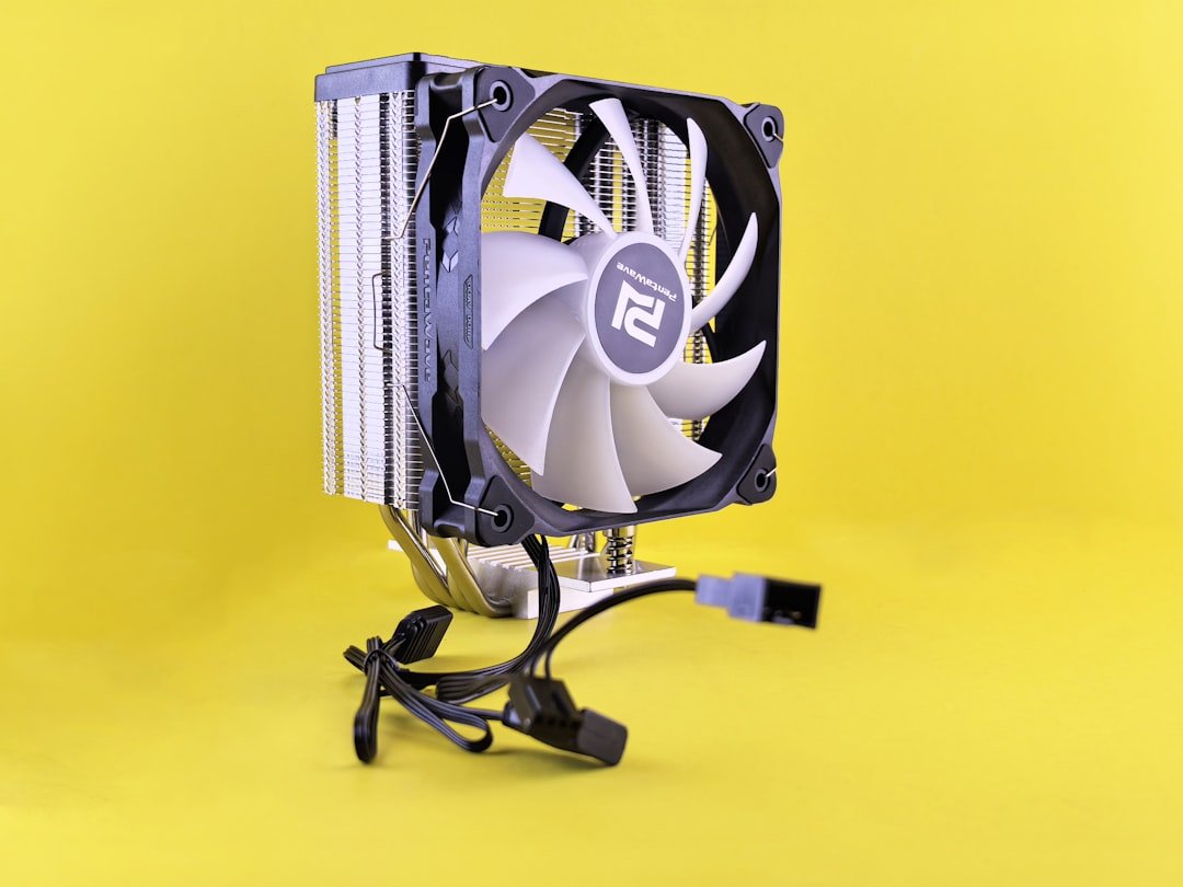 A computer fan sitting on top of a yellow surface