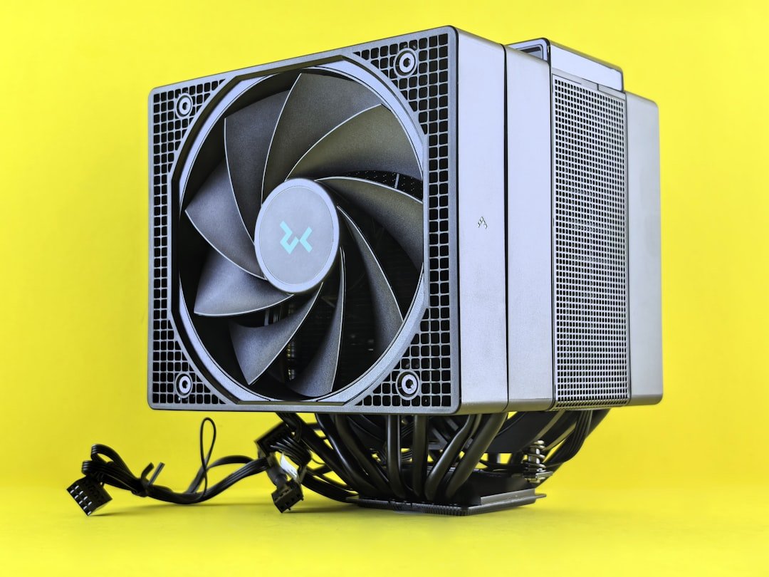 A computer cpu cooler sits on a yellow surface.