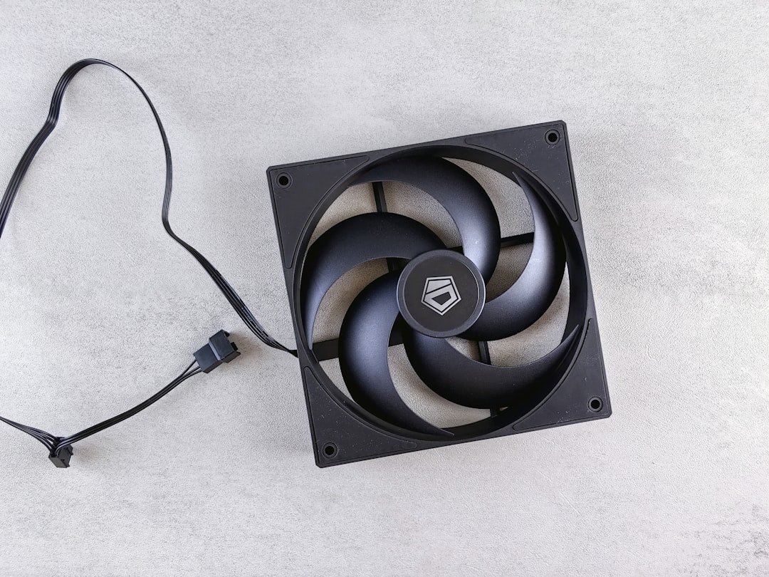 A computer fan sitting on top of a white surface
