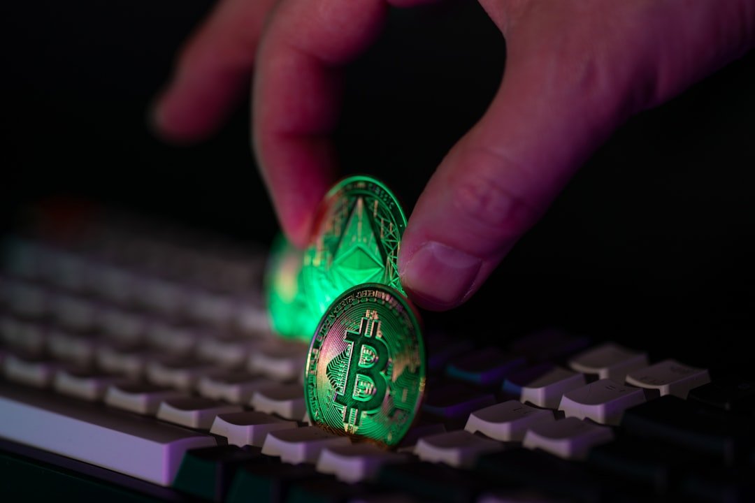 Hand placing glowing crypto coins on a keyboard.