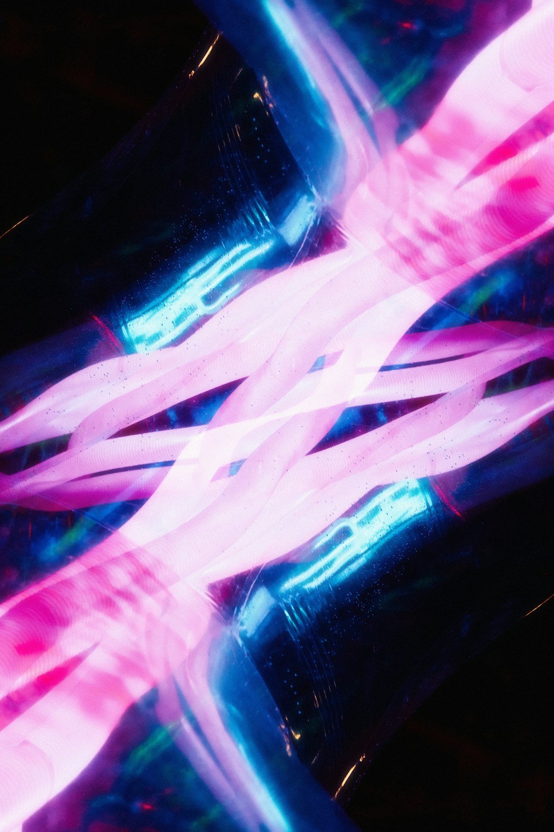 A blurry photo of a pink and blue object
