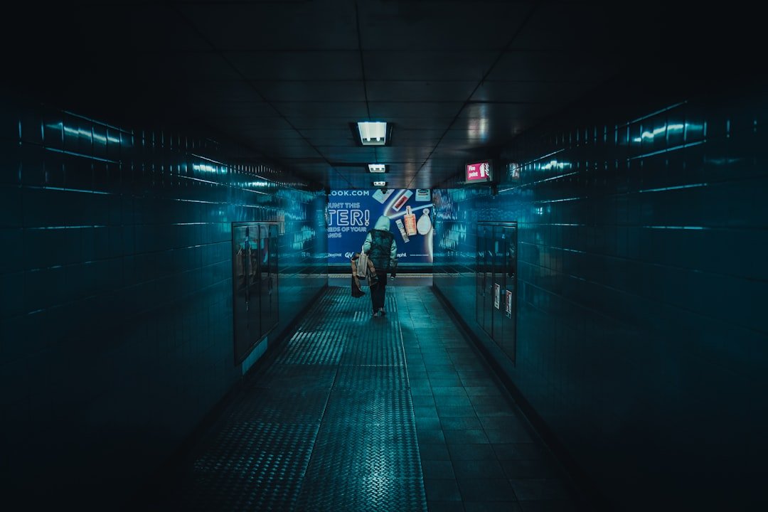 a person walking down a hallway in a building