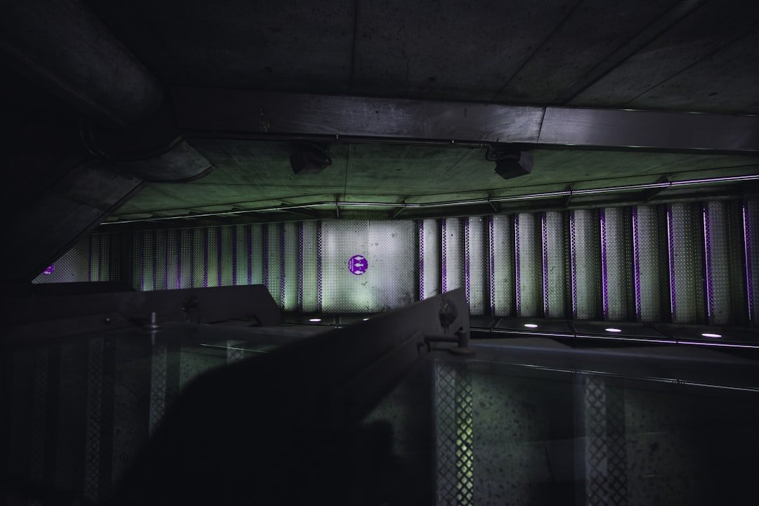 a dark room with a purple light in the corner