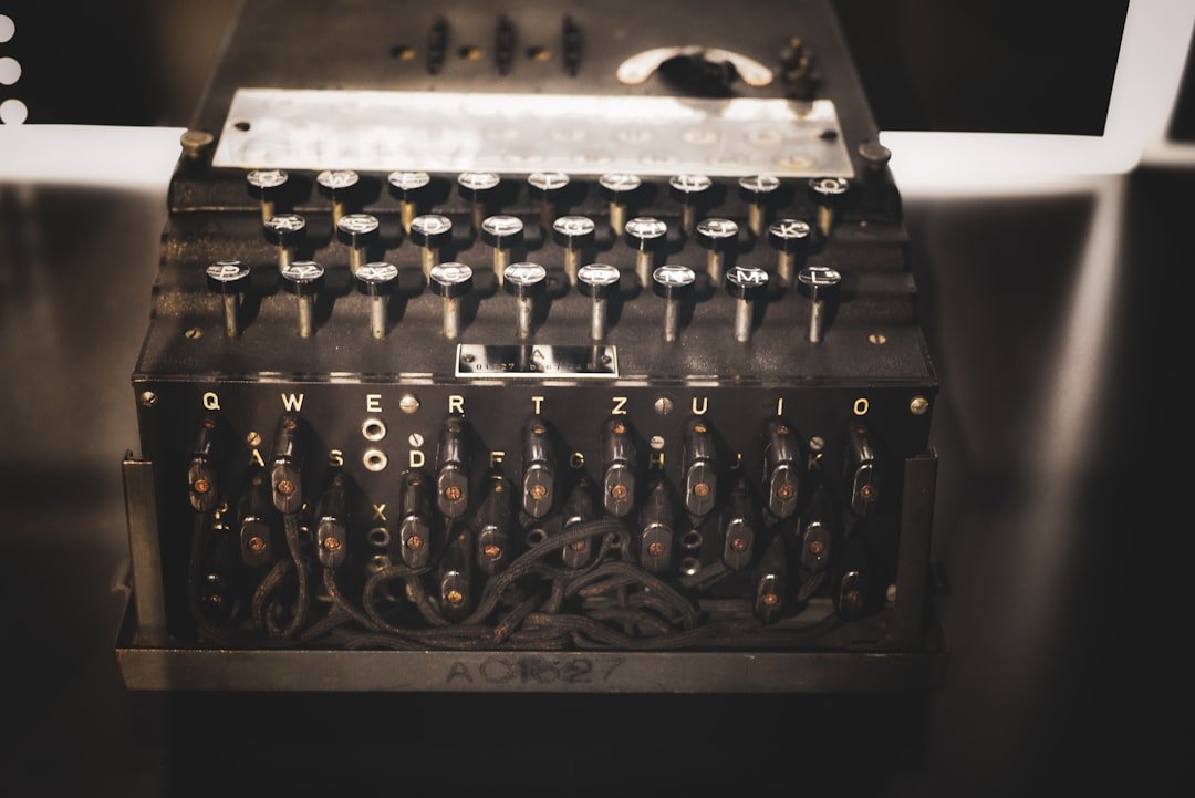 An old typewriter sitting in front of a computer