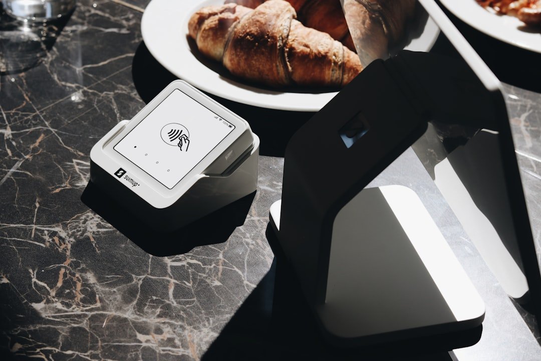 A table topped with plates of food and a laptop