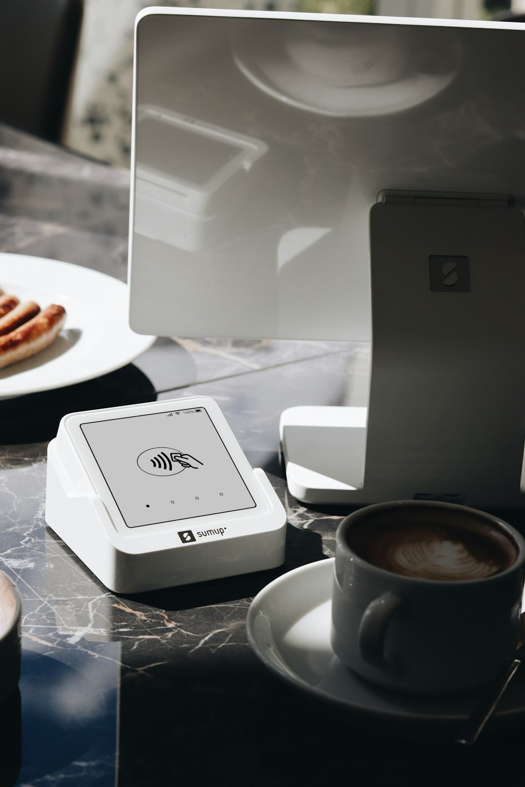 A table topped with a laptop computer next to a cup of coffee