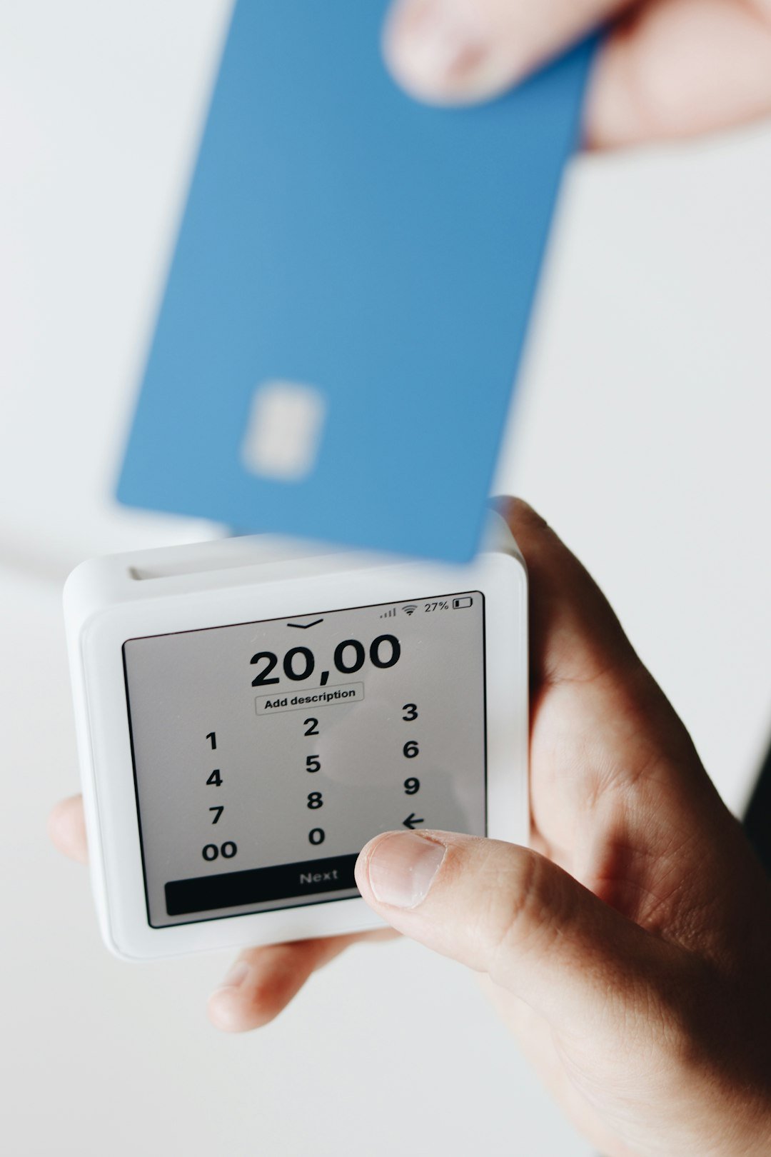 A person holding a cell phone in their hand