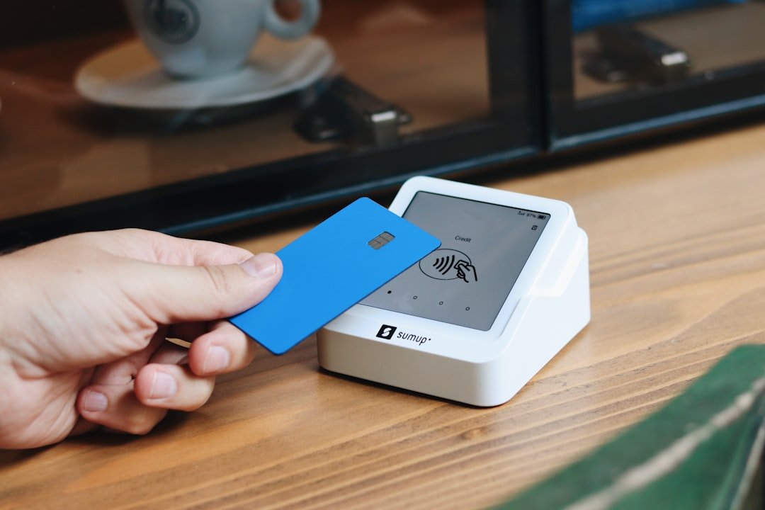 A person holding a blue card in their hand