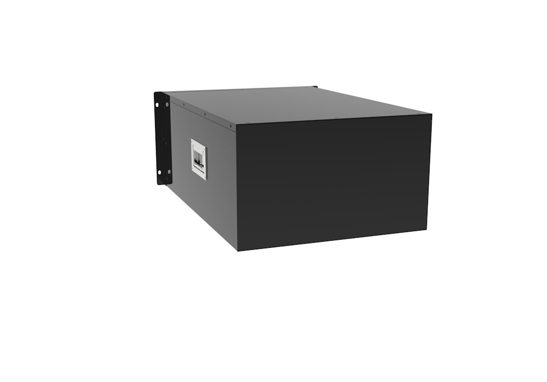 a black box sitting on top of a white wall