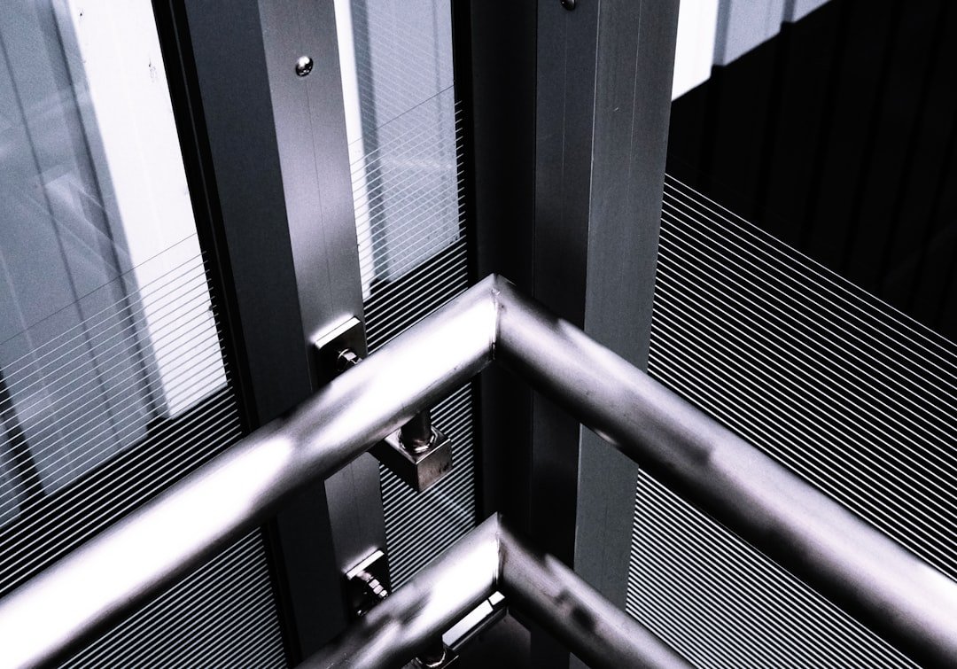 a black and white photo of a metal railing