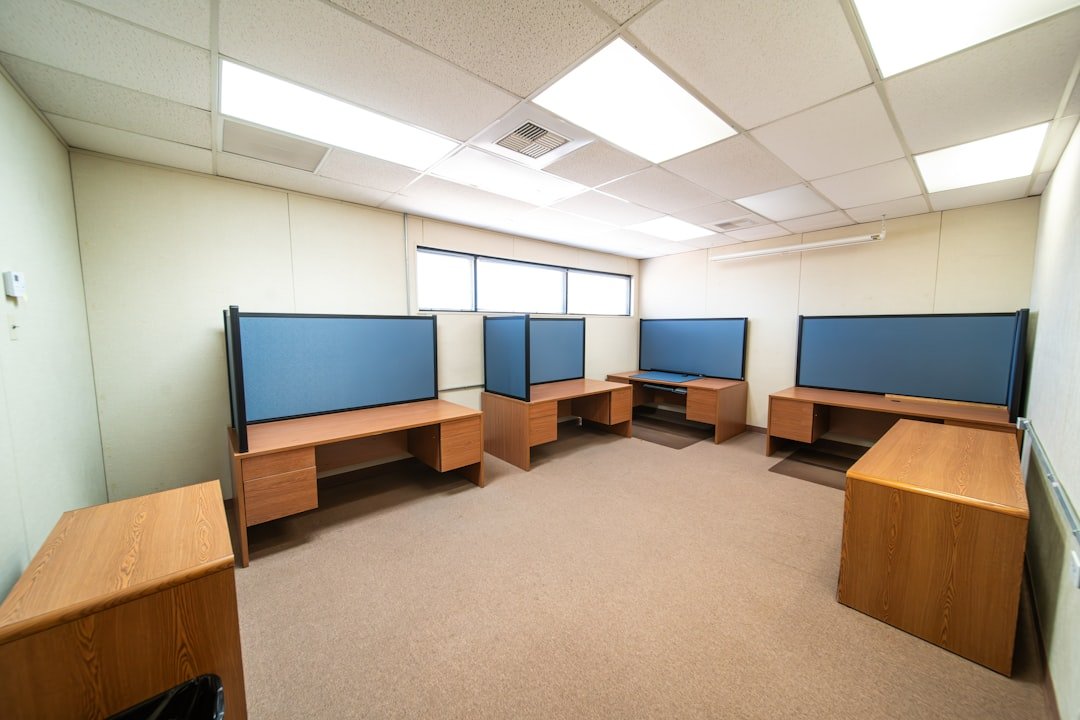 a room with a lot of desks and monitors