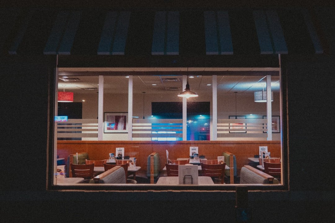 A diner's interior is seen through its windows.