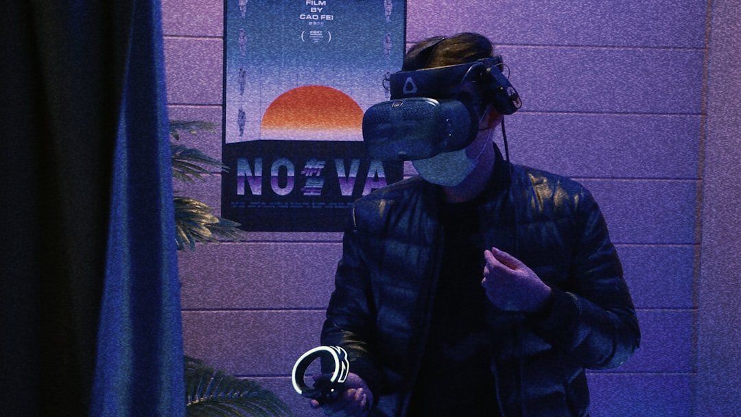 man in black leather jacket holding black and blue dslr camera