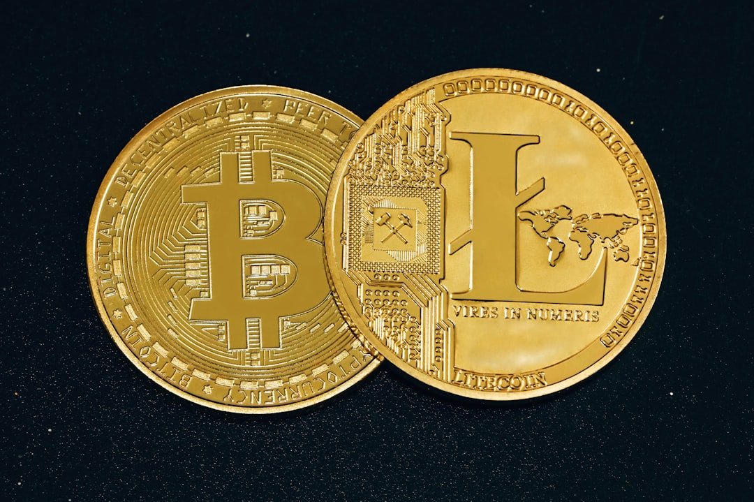 two gold bitcoins sitting side by side on a black surface